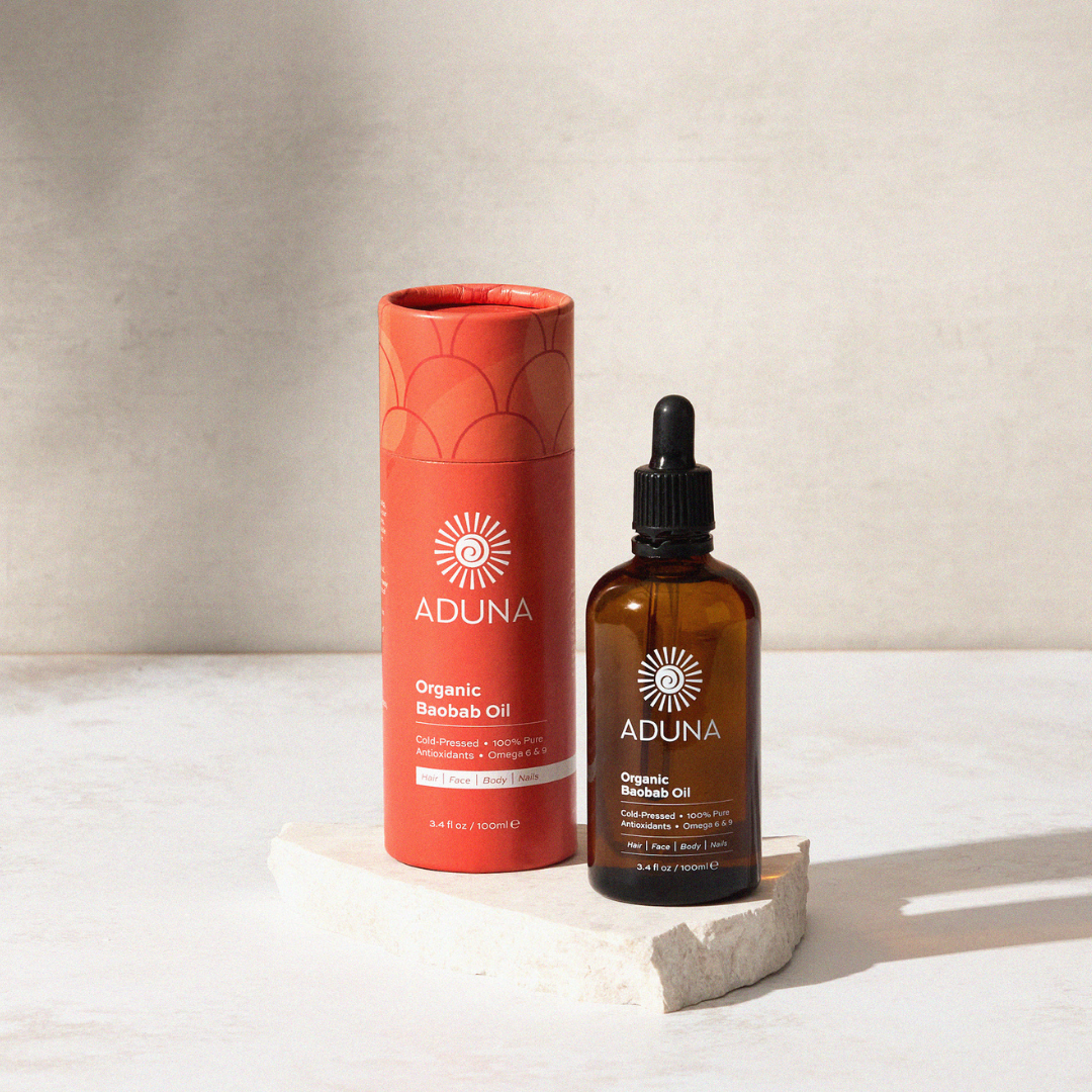 Aduna Baobab Beauty Oil with Tub on a marble surface