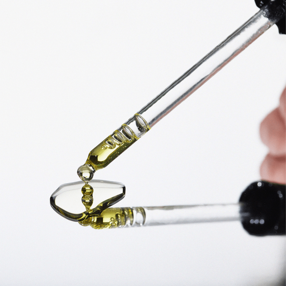 Close-up of a dropper with Moringa Beauty Oil on a white background