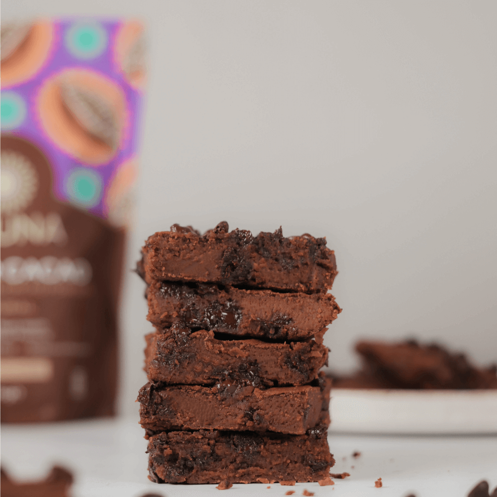 Stack of five chocolate brownies containing Aduna Super Cacao Powder.
