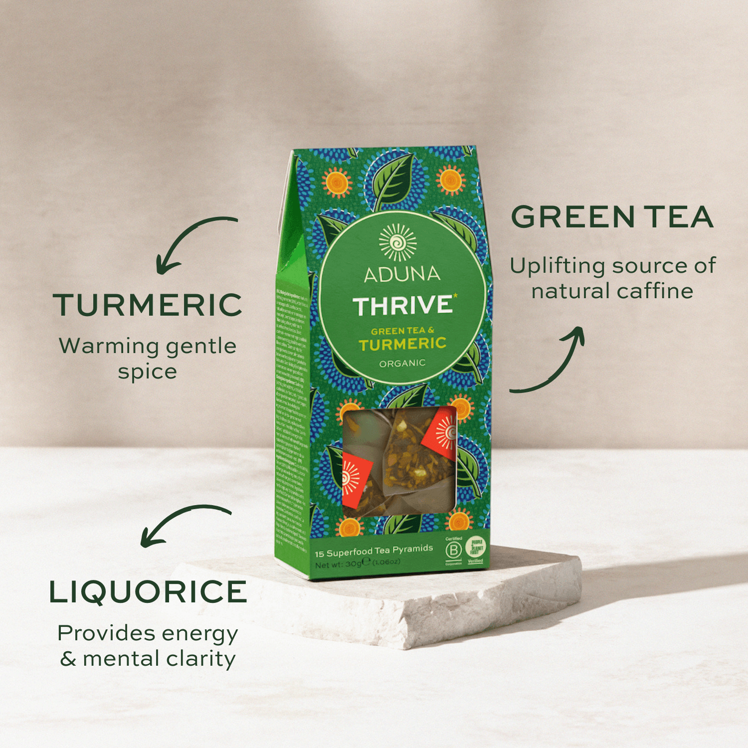 Aduna Thrive green tea packaging with turmeric and liquorice on a neutral background.