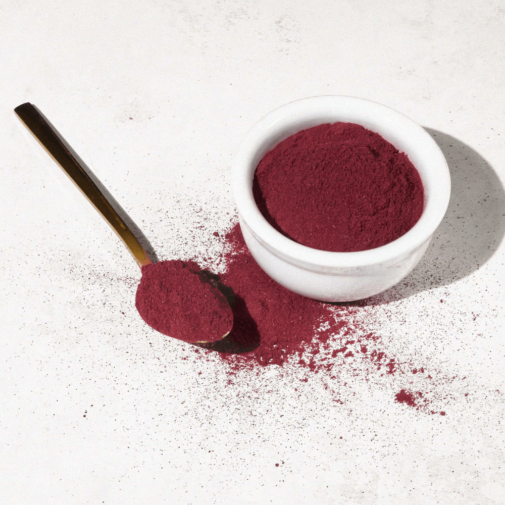 Aduna Hibiscus Powder on a spoon and in a small white pot
