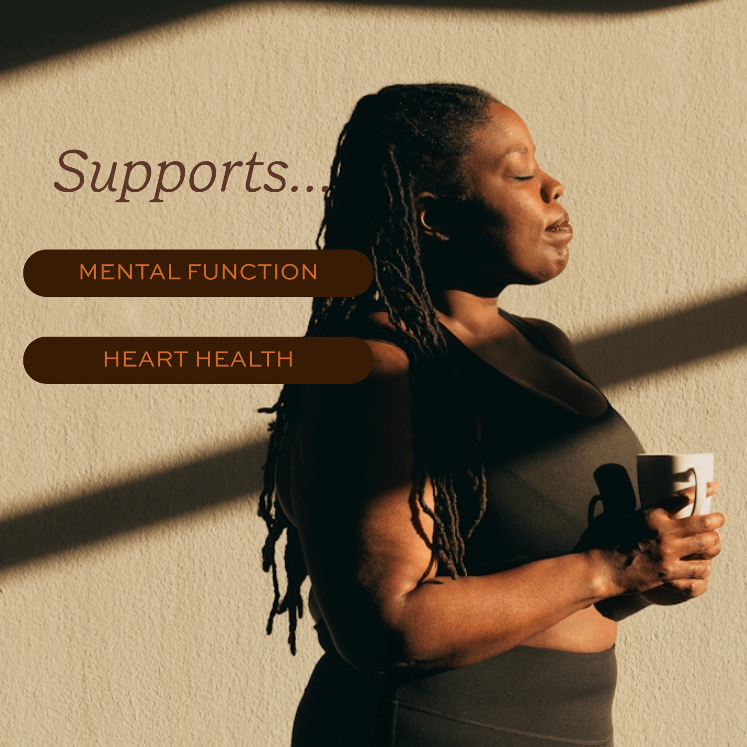 Person holding a mug with text about mental function and heart health support on a neutral background.
