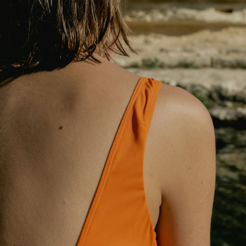 Close-up of woman's back and shoulder with good skin health.