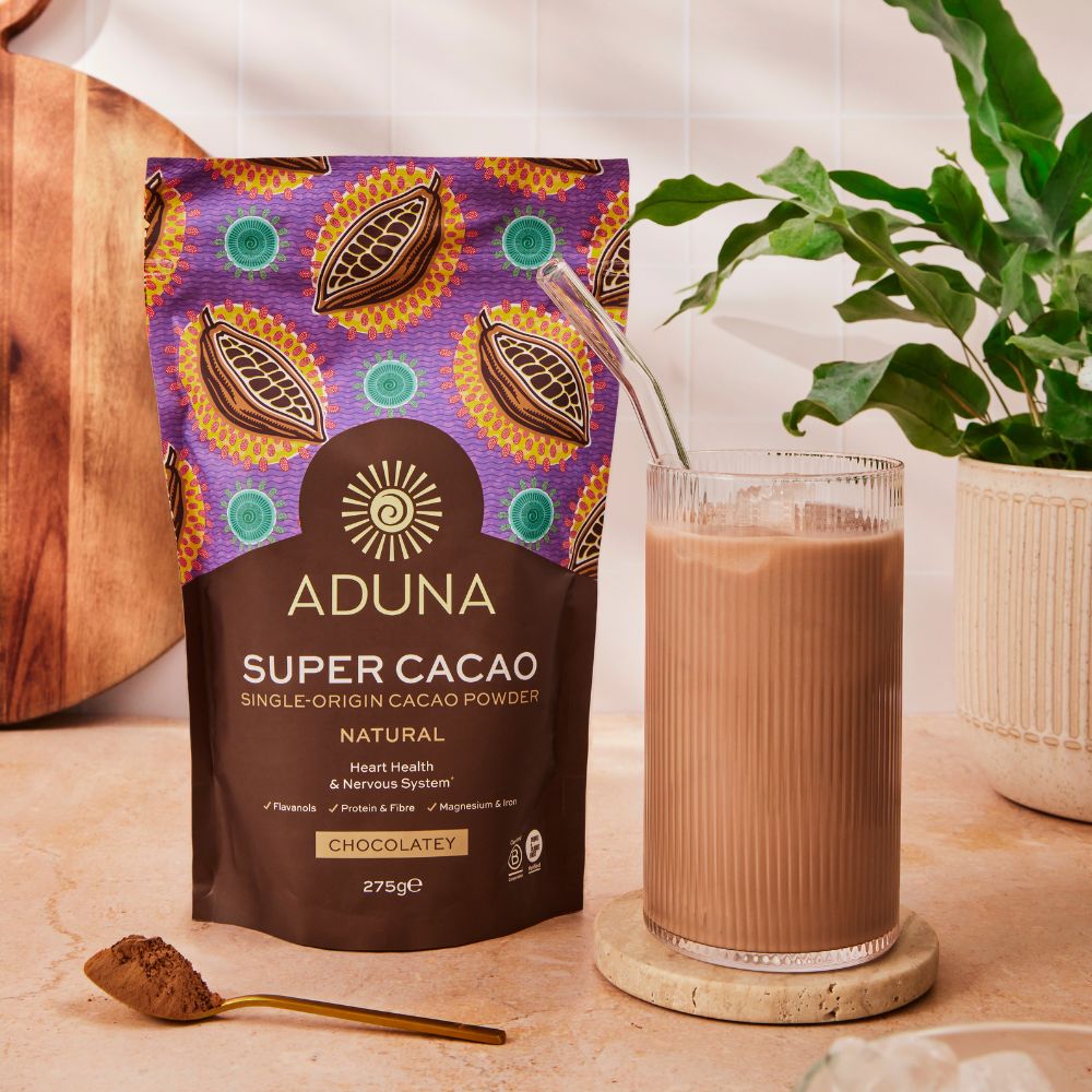 Aduna's Super Cacao Powder with a delicious iced cacao drink on a ktichen worktop