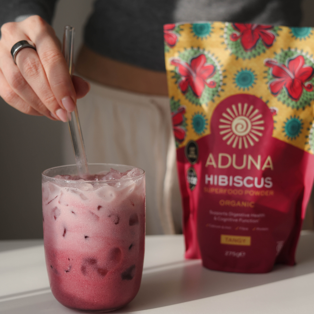 A pouch of Aduna Hibiscus being used in a drink