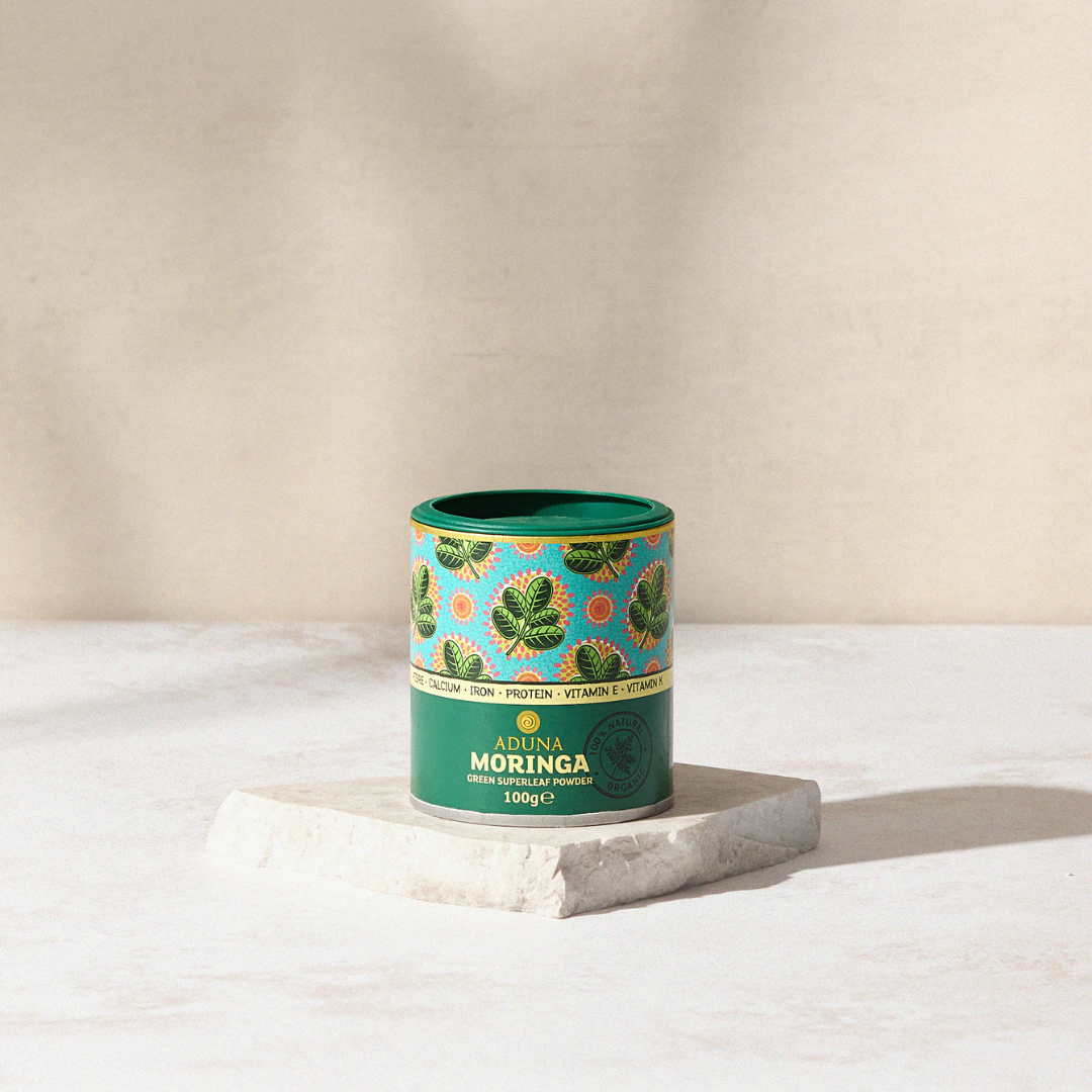 Aduna Moringa Powder Tub displayed on a marble stand