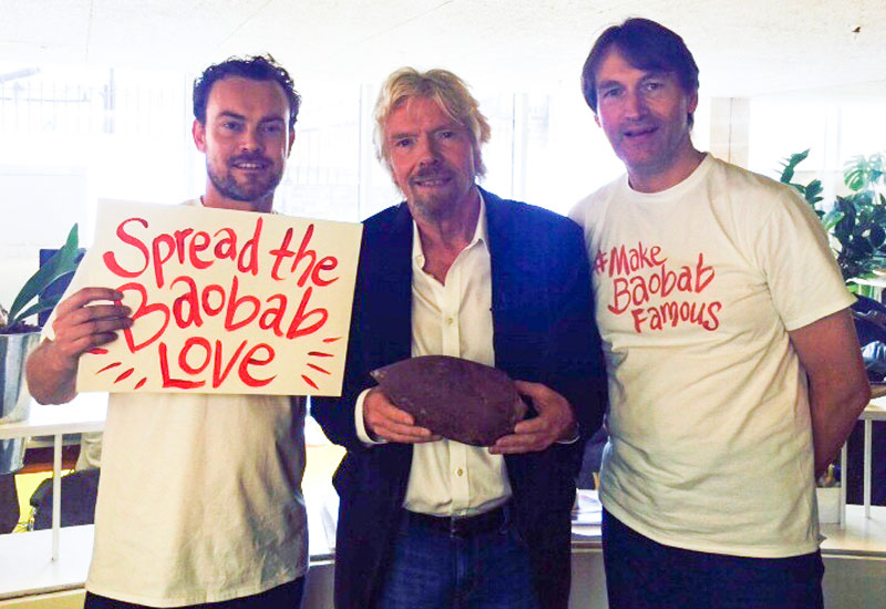 Richard Branson holding a baobab with Aduna's founders